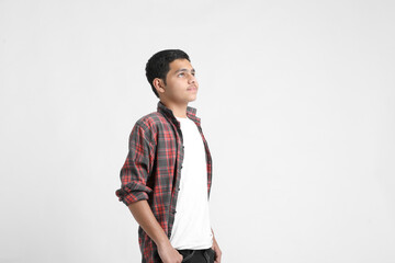 Fototapeta premium Young indian boy in a casual outfit and showing expression on white background.