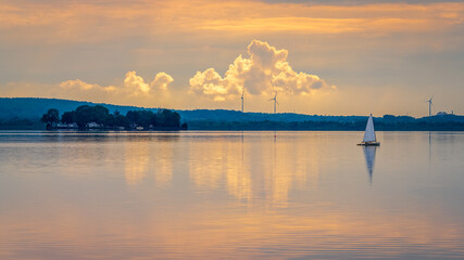 Evening at the Steinhuder Meer with a boat sailing and the Wilhelmstein island in the background, seen in Steinhude, Lower Saxony, Germany