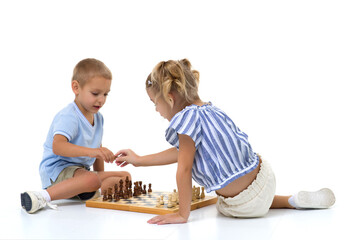 Boy and girl playing chess board game