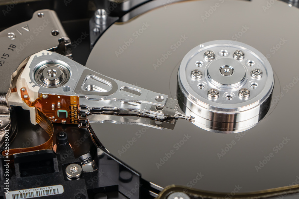 Poster disassembled hard drive from the computer, hdd with mirror effect. opened hard drive from the comput