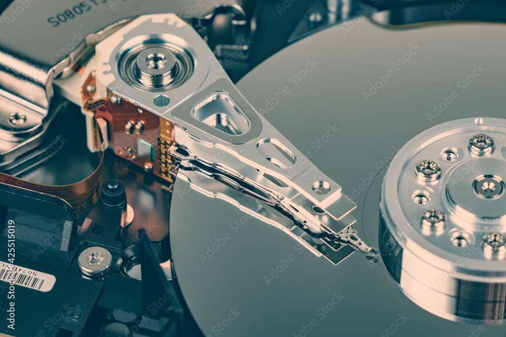 Poster disassembled hard drive from the computer, hdd with mirror effect. opened hard drive from the comput