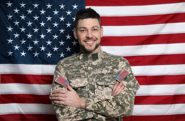 Portrait of happy cadet against American flag
