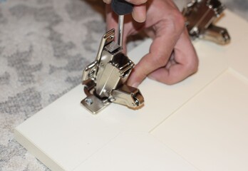 installation of a furniture hinge by a master