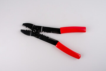 Naklejka premium Red and black equipment plastic metal cutter pliers for electrical cable