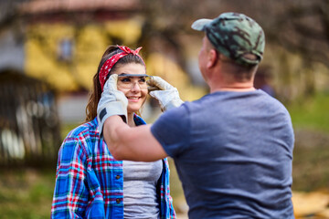 a man protects his woman by wearing glasses.