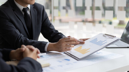 Brainstorm team, Marketers and financial accountants are discussing and analyzing charts to plan strategies to meet customer needs, Computer technology for business concept.