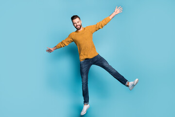 Full length body size view of nice attractive cheerful guy jumping like star having fun isolated on bright blue color background