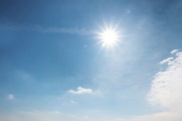 Naklejka na ściany i meble Sun and white clouds in blue sky outdoors