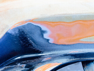 repair of paintwork on cars.applied putty on a special type of car.
