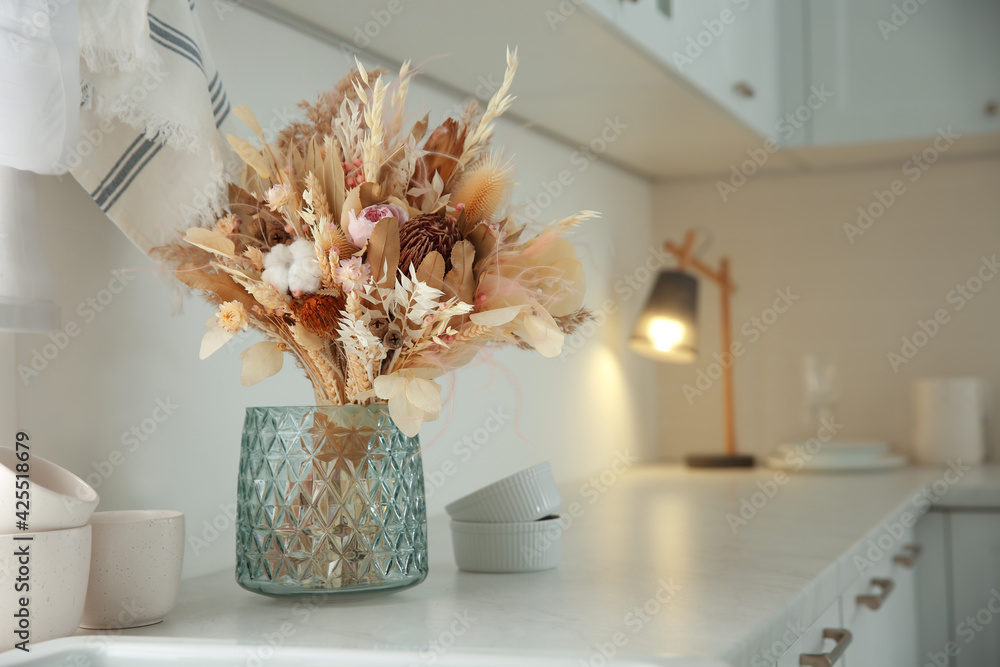 Canvas Prints Bouquet of dry flowers and leaves on countertop in kitchen. Space for text