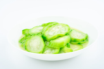 A dish of angular loofah on a white background