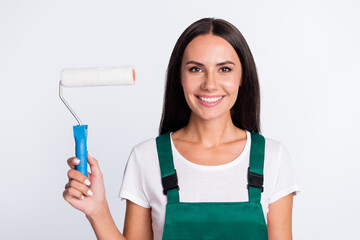 Photo of worker painter lady hold roller toothy smile look camera wear green overall isolated white color background