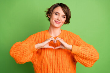 Photo of attractive lovely young woman make hands heart shape romantic mood isolated on green color...