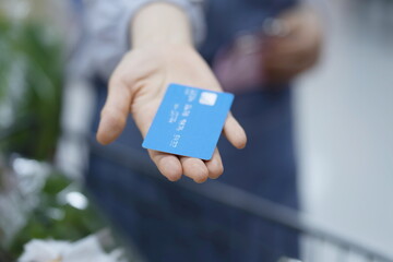 Woman paying with credit card in supermarket