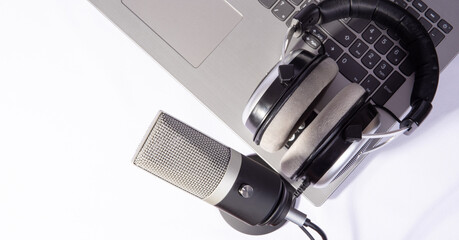 home work, professional condenser headset microphone and computer, white background, top view.