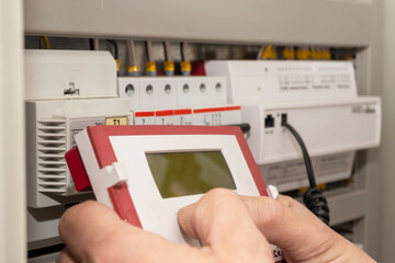 The electrician engineer programs the electrical control circuitry of the electrical system. Smart...