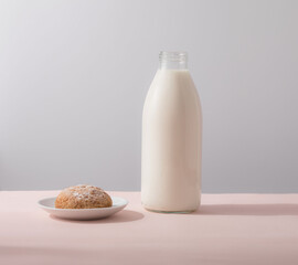 Oatmeal cookies and milk in bottle, healthy snack. Light background