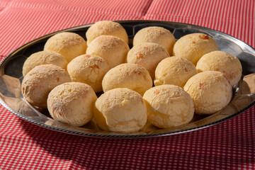 Cheese bread, round shape filled with cheese bread that has just come out of the oven on a checkered tablecloth, selective focus.