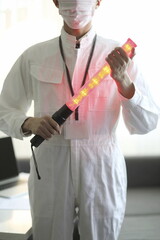 Cropped image of worker holding traffic rod