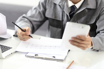 Engineer Using Digital Tablet At Desk In Office