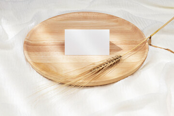 Business card mockup on wooden plate 