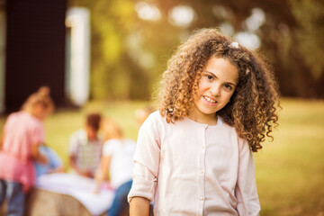 Young smiling schoolgirl looking to camera.