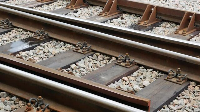 Train tracks, railroad tracks rails steering switch, turnouts closeup, detail panning shot. Rail transportation, travelling, fork, indecision, deciding, changing direction simple abstract concept