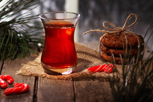 Hot tea on a winter evening. Armuda with tea. Tea with cookies and Christmas sweets. Selective focus.
