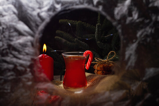 Hot tea on a winter evening. Armuda with tea. Look into the house through the frozen window. Selective focus.