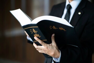 Lawyer holding code of law.Chinese character 'beobjeon' means code of laws,law book.