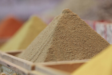 Spices are pouring in shape of pyramid closeup