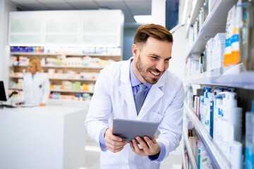 Pharmacist checking medics inventory on tablet computer in drug store.