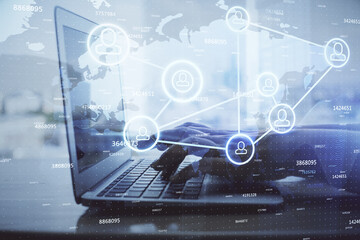 Double exposure of woman hands typing on computer and social network theme hologram drawing. People media concept.