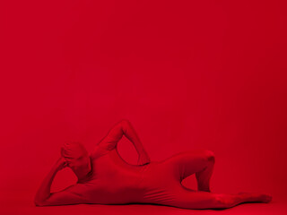 crazy red man on a red background. figure in a leotard covering the whole body