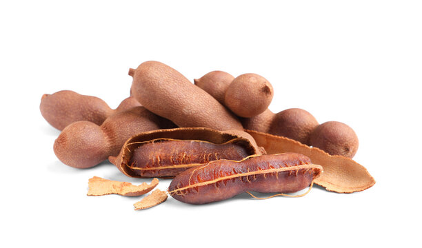 Delicious ripe tamarinds on white background. Exotic fruit