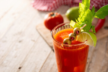 Bloody Mary cocktail in glass on rustic wooden table. Copy space	