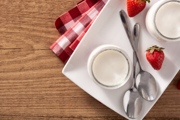 Panna cotta dessert with strawberry on wooden table.Top view. Copy space