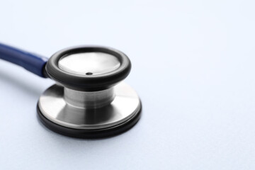 Stethoscope on white background, closeup. Space for text