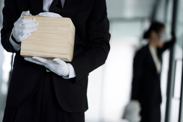 Bereaved holding urn at funeral