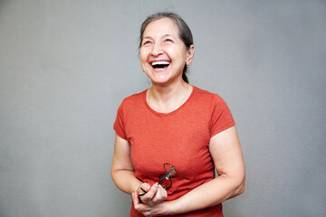 55-year-old woman laughs and looking up