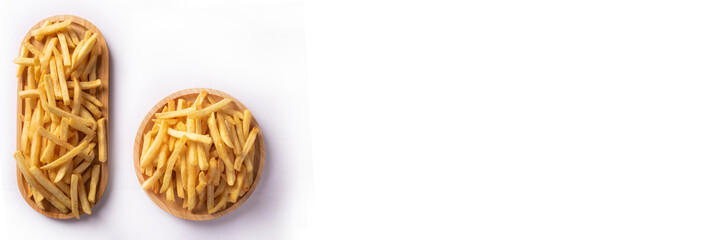 French fries placed on a round wooden plate and on a long wooden plate, white background, selective focus.