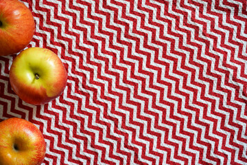 Red table cloth zigzag texture with apples