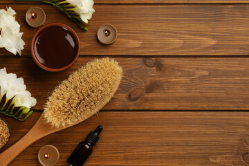 Flat lay composition with cosmetic products on wooden background, space for text. Spa body wraps