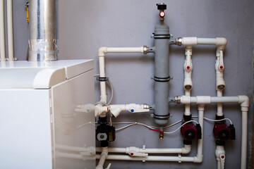 Heating system of a private house, boiler room with gas equipment, water pipes. Dispensing vessel container.