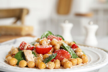 Plate with delicious fresh chickpea salad on table, closeup