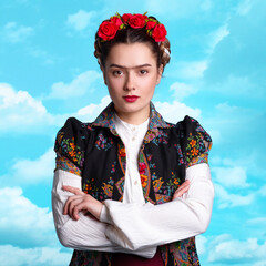 young woman in the image of the Mexican artist Frida with red roses in her hair.