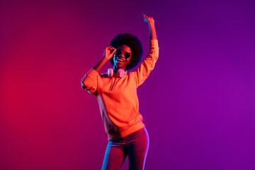 Photo of attractive cheerful dark skin person arm touch sunglass beaming smile isolated on bright background