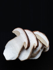 Delicious perfectly clean porcini mushroom slices isolated on black background
