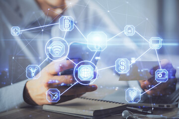 Double exposure of man's hands holding and using a phone and social network theme drawing.