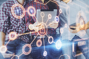 Double exposure of social network theme drawing and man and woman working together holding and using a mobile device.